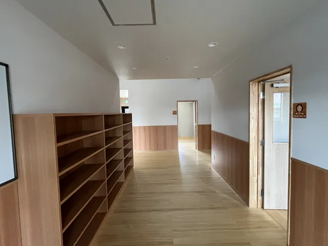 木の棚が続く明るい廊下